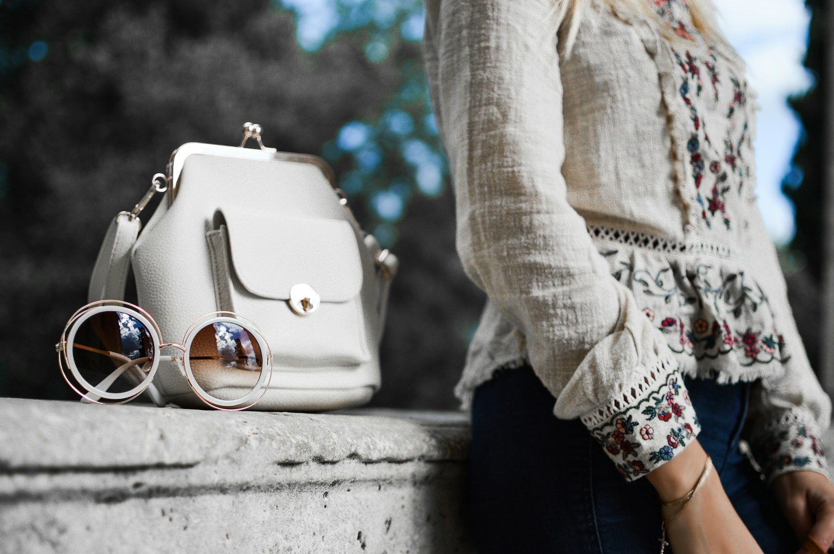 White day bag and sunglasses styled with a cream outfit.
